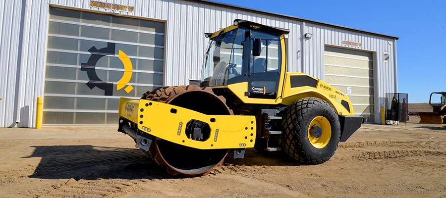 Bomag ride on compactor in front of the Conquest shop doors
